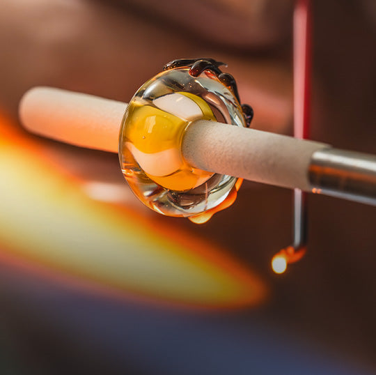Artistic glass bead in the making, capturing grace and tranquility in delicate glasswork