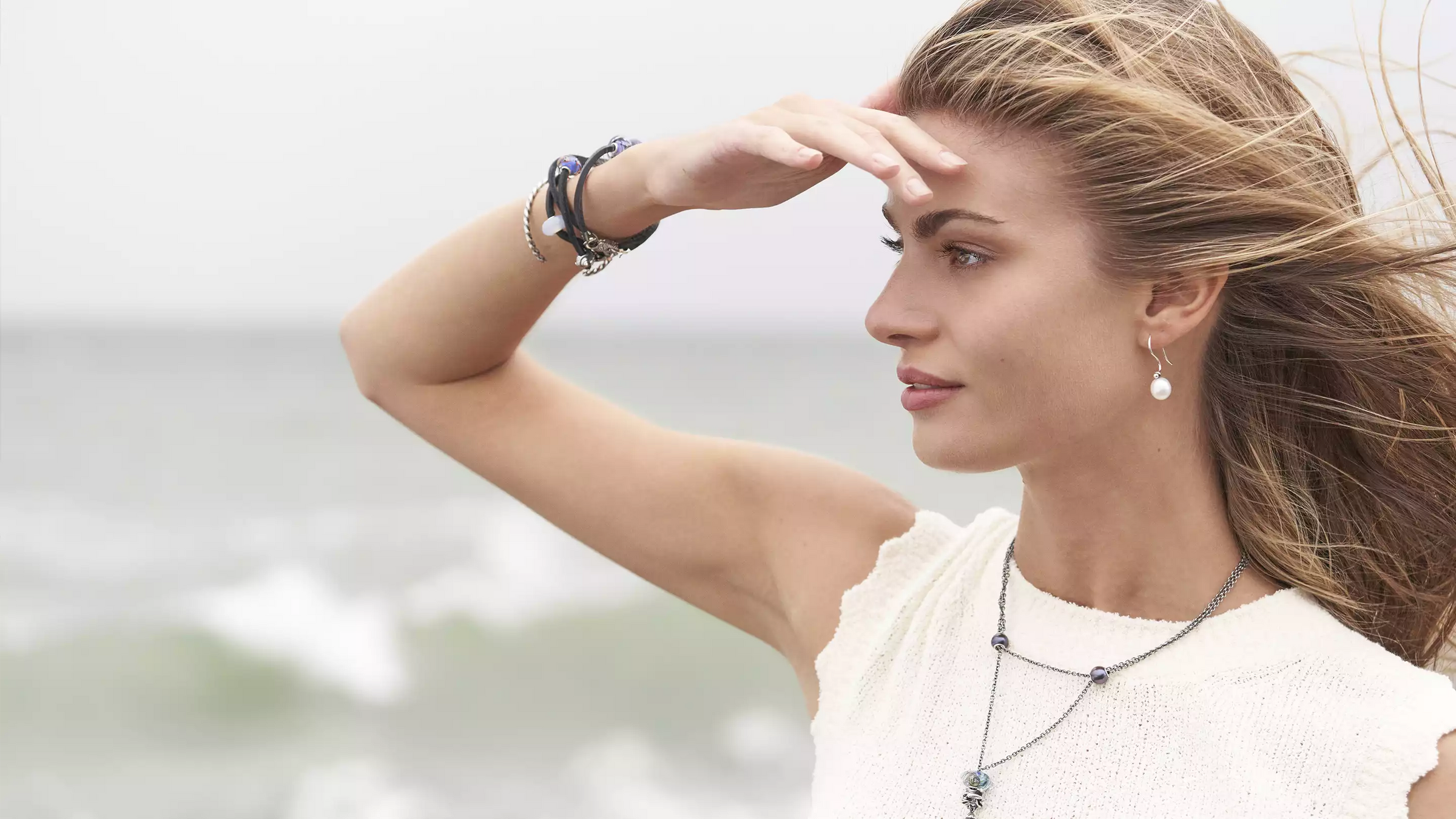 Model at the beach wearing Trollbeads jewellery