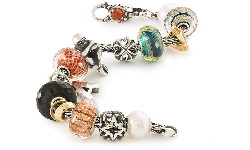 Trollbeads foxtail bracelet with beads in pearl, glass, silver, and stone, symbolizing the felling of togetherness